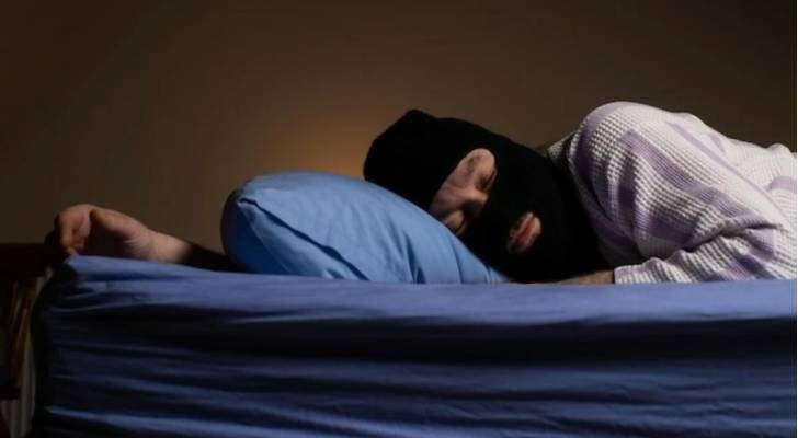 لص ينام داخل شقة بعد جمع المسروقات