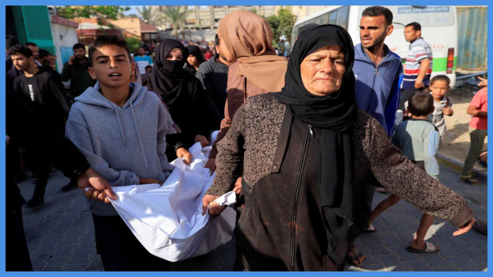 سيدة تحمل جثمان شهيد في مستشفى ناصر في خان يونس